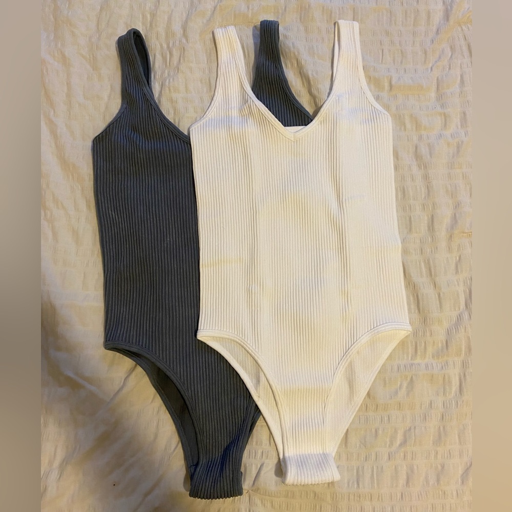 Two tank top body suits